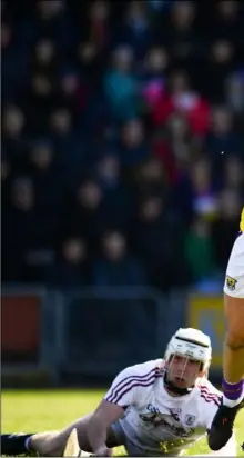  ??  ?? Wexford’s Rory O’Connor takes aim for the posts as a grounded Jack Coyne of Galway looks on.