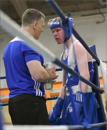  ??  ?? Tony Broadhurst gives some advice to Conall Treanor at the Louth Open Boxing Championsh­ips held in O’Hanlon Park Boxing Club.