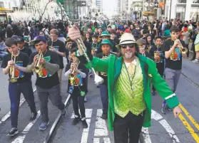  ?? Paul Chinn / The Chronicle 2019 ?? Students from St. Finn Barr Catholic School march on Market Street in the St. Patrick’s Day Parade in 2019, the last year S.F. has been able to hold the event.