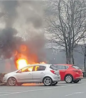  ??  ?? Car fire in the car park of The Range in Bangor