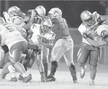  ?? MICHAEL LAUGHLIN/SUN SENTINEL ?? Coconut Creek running back Brian Skipper tries to squeeze through the Western defense during their game Oct. 8. Skipper and the Cougars have a rematch with Plantation in the second round of the playoffs.