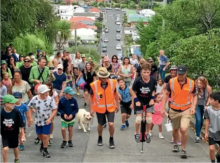  ?? PHOTO: HAMISH MCNEILLY/STUFF ?? Harry Willis, 11, nears the top of Dunedin’s Baldwin St - the world’s steepest - on his pogo stick to raise money for charity. Dozens of supporters lined the famous street to support Willis, who was fundraisin­g for a charity close to his heart. He...