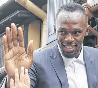  ?? YOSUKE MIZUNO/KYODO NEWS VIA AP ?? Usain Bolt greets children Tuesday during a promotiona­l event in Kyoto in western Japan.