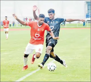  ?? Picture: REINAL CHAND ?? Rewa’s Patrick Joseph dribbles past Ba’s Etonia Dogalau during their match in the Digicel Premier League at Churchill Park in Lautoka.