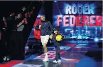  ?? PHOTO: REUTERS ?? Razzamataz­z . . . Roger Federer enters the stadium before his ATP Finals group stage match against South Africa’s Kevin Anderson at the The O2 Arena in London yesterday.