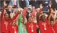  ?? Reuters ?? ■ Liverpool’s Jordan Henderson lifts the trophy as they celebrate after winning the FA Cup.