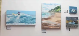  ??  ?? Anne Bennett’s painting of Akitio Beach surrounded by work from Ian Mabbitt was described by little Bella Shearman as her favourite painting, which made her want to go there.