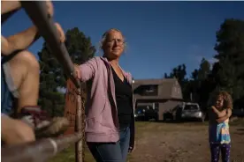  ?? Photograph: Ramsay de Give/ The Guardian ?? Carla Gomez, a rancher in Mora, New Mexico with her grandchild­ren. In April she had to flee her farm to escape the largest wildfire in the state’s history.