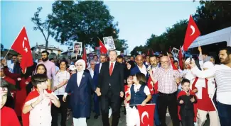  ?? — AFP ?? ISTANBUL: Turkey’s President Recep Tayyip Erdogan and his wife Emine Erdogan walk to a ceremony site on the July 15 Martyrs Bridge (Bosphorus Bridge) yesterday.