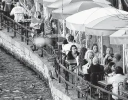  ?? Billy Calzada / Staff photograph­er ?? People dine at Casa Rio on the River Walk in early March. Over a third of U.S. job losses in the pandemic occurred in the leisure and travel industry.
