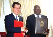  ?? ?? Public Works Minister July Moyo shakes hands with Chinese Ambassador to Zimbabwe Guo Shaochun after the signing ceremony at State House in Harare yesterday