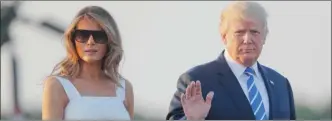  ?? The Associated Press ?? President Donald Trump and first lady Melania Trump walk across the tarmac before boarding Air Force One at Morristown Municipal Airport on Sunday.