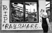  ?? ELIJAH NOUVELAGE/GETTY-AFP ?? “RIP Rayshard” is spray-painted on a burned Wendy’s on Sunday after the police shooting of Rayshard Brooks.