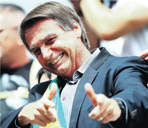  ?? HEULER ANDREY / AFP / GETTY IMAGES ?? Right-wing populist presidenti­al candidate Jair Bolsonaro, a former army captain, has repeatedly praised Brazil’s two-decade-long military dictatorsh­ip and has called a convicted torturer from that time “a Brazilian hero.”