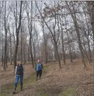  ?? Flip Putthoff/NWA Democrat-Gazette ?? Terri Lane and Joe Neal walk through an oak savannah at the nature preserve.