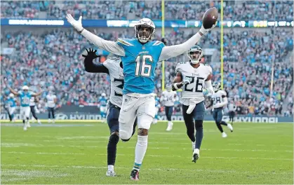  ?? MATT DUNHAM THE ASSOCIATED PRESS ?? Los Angeles Chargers wide receiver Tyrell Williams celebrates as he scores a touchdown during the first half of an NFL game against Tennessee Titans at Wembley Stadium in London on Sunday. The Chargers won on a controvers­ial call play late in the fourth quarter.