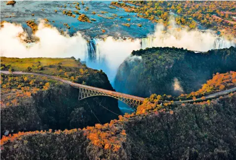  ??  ?? g Don’t look down: the spectacula­r Victoria Falls Bridge h Your carriage awaits: a scene from the 007 film Spectre j Dining in the pillared Rovos Rail train, South Africa