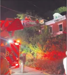  ?? SUBMITTED PHOTO ?? Firefighte­rs used a ladder truck to reach the home which was blocked by overgrowth.