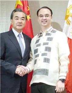  ?? — AFP photo ?? Wang (left) shakes hand with Philippine Foreign Affairs scretary Alan Peter Cayetano in Manila.