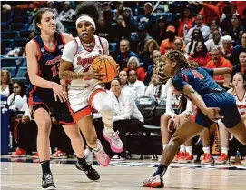  ?? Jessica Hill/Associated Press ?? Syracuse’s Dyaisha Fair cuts between Arizona’s Helena Pueyo, left, and Skylar Jones in the second half on Saturday.