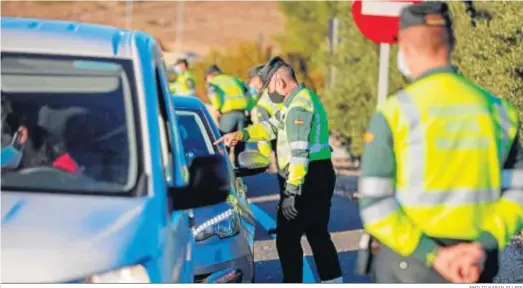  ?? EMILIO NARANJO / EFE ?? Agentes de la Guarda Civil, en un control de tráfico ayer en la A4 en la salida de Madrid.