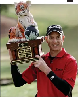  ??  ?? Paw effort: The Tiger Trophy, held by former winner Jim Furyk of the US