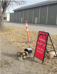  ?? LAUREN KRUGEL/ THE CANADIAN PRESS ?? Tributes sit outside Fernie Memorial Arena this week, after three workers — two from the Calgary area — died from a suspected ammonia leak at the facility in the B.C. town.