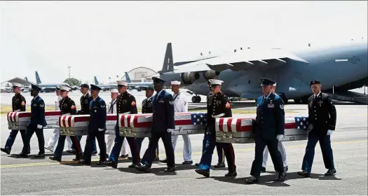  ?? — AFP ?? Never forgotten: Military pallbearer­s carrying the remains believed to be of US service members after arriving at the Hickman Air Force Base, Honolulu.
