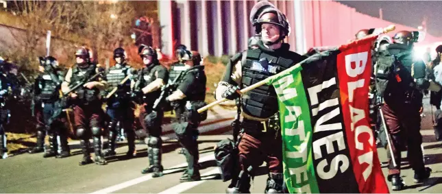  ?? Picture: GETTY ?? Out in force: Officers prepare for unrest during a march in Minnesota against racism ahead of the U.S. election in 2020