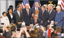  ?? RICK BOWMER — THE ASSOCIATED PRESS ?? President Donald Trump signs a proclamati­on at the Utah State Capitol on Monday to shrink the size of Bears Ears and Grand Staircase Escalante national monuments.