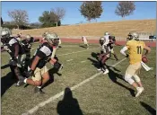  ?? JUSTIN COUCHOT/ENTERPRISE-RECORD ?? Butte College defensive lineman Alex Tapia (95) rushes redshirt quarterbac­k Rieger Sayre during the Roadrunner­s practice on Wednesday in Butte Valley.