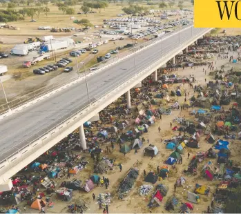  ?? JULIO CORTEZ / THE ASSOCIATED PRESS ?? Migrants are seen at an encampment by the Del Rio Internatio­nal Bridge in Texas Tuesday. The U.S. government has been returning thousands of migrants to Haiti amid reports of abuse and mistreatme­nt by border guards.