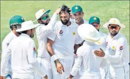  ?? AFP ?? ■ Pakistan spinner Bilal Asif (C) celebrates with teammates after dismissing Australia opener Usman Khawaja on the third day of the first Test in Dubai on Tuesday.