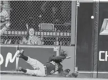  ??  ?? Mariners center fielder Mallex Smith dives but cannot come up with the catch of Yuli Gurriel's blast to right-center that falls for a walkoff double at Minute Maid Park.