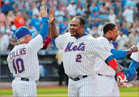  ?? KATHY WILLENS/AP PHOTO ?? Manager Terry Collins and Juan Uribe, who joined the team Saturday after a trade, celebrate after Uribe hit a game-winning single in the 10th inning to give the Mets a 3-2 victory over the Los Angeles Dodgers on Sunday.