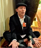  ??  ?? Li Liancheng assis par terre lors de l’interview