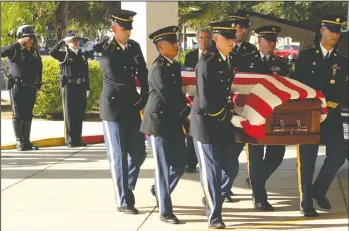  ?? NEWS-SENTINEL FILE PHOTOGRAPH ?? Lodi Police officers Chris Kaufman, left, and Carlos Fuentes salute as the U.S. Army Honor Guard moves the casket containing the body of U.S. Army Spc. Kyle Coumas into Century Assembly Church on Nov. 2, 2009. Coumas was killed in Afghanista­n on Oct. 21, 2009, and Lodi Police Capt. Chris Jacobson will compete in the 60-mile Ruck to Remember hike in West Virginia today, in remembranc­e of Coumas.