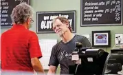  ?? [AP PHOTO] ?? Baker Jack Phillips, owner of Masterpiec­e Cakeshop, right, manages his shop Monday in Lakewood, Colo. The Supreme Court ruled Monday in favor of Phillips, who wouldn’t make a wedding cake for a same-sex couple, in a limited decision that leaves for...