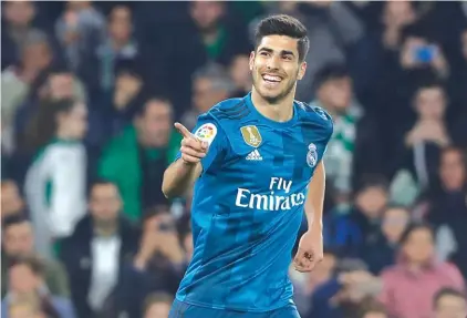  ??  ?? Real Madrid’s Asensio celebrates after scoring against Betis Photo: AP