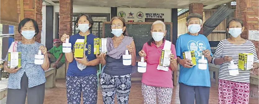  ?? ?? A GROUP of senior citizens from Abra show off new solar lamps distribute­d by One Meralco Foundation, with the assistance of Meralco Employees Fund for Charity Inc. and Meralco employee volunteers after a strong earthquake hit the province in 2022.