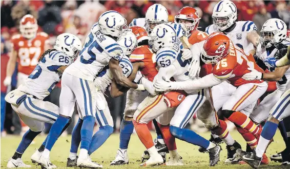  ??  ?? It took a host of Indianapol­is Colts defenders to stop Kansas City Chiefs running back Damien Williams on a run in the third quarter in an AFC Divisional game on Saturday at Arrowhead Stadium in Kansas City, Missouri.