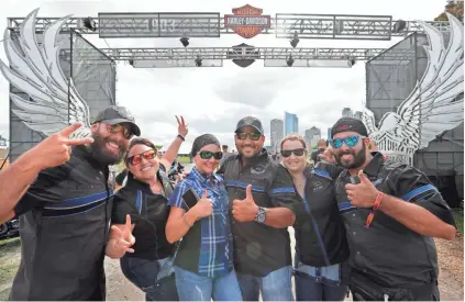  ?? RICK WOOD / MILWAUKEE JOURNAL SENTINEL ?? Joseyos Fiallo (from left), May Savignon, Marta Ledezma, David Ledezma, Wendy Miranda and Jamner Moreno, all from Miami, relax after a three-day ride from their hometown to Milwaukee. They gathered as riders started to pour into Milwaukee for Harley-Davidson’s 115th anniversar­y kickoff celebratio­n at Veterans Park at the lakefront. More photos and videos at jsonline.com.