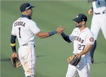  ?? Kevork Djansezian, Getty Images ?? Houston’s Carlos Correa ( 1) and Jose Altuve ( 27) are back in the ALCS months after not being punished for participat­ing in the team’s infamous cheating scandal.