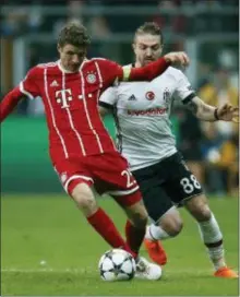  ?? THE ASSOCIATED PRESS ?? Bayern’s Thomas Mueller, left, controls the ball as Besiktas’ Caner Erkin tries to stop him during the Champions League round of 16 match between Besiktas and Bayern Munich.