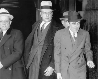  ??  ?? El estafador, a la derecha de la imagen, abandona el tribunal, rumbo a la prisión de Alcatraz, tras ser sentenciad­o a veinte años de cárcel, en septiembre de 1935.