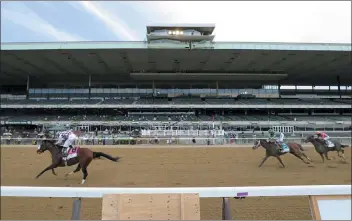  ?? SETH WENIG – THE ASSOCIATED PRESS ?? Tiz the Law, left, with jockey Manny Franco up, crosses the finish line ahead of Dr Post and Max Player, right, in front of an empty grandstand Saturday to win the 152nd running of the Belmont Stakes in Elmont, N.Y. But since it was run at a mile-and-eighth rather than a mileand-half length ... was it really the Belmont Stakes?