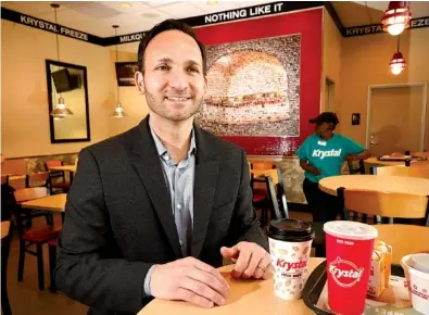  ?? STAFF PHOTO BY TIM BARBER ?? Paul Macaluso, CEO of Krystal restaurant­s, talks Monday about trying to boost profits after taking the helm of the Atlanta-based company. Longtime employee Pat “Miss Pat” Lawson is also seen in the dining area of the restaurant’s Broad Street location...