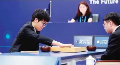  ??  ?? WUZHEN: China’s 19-year-old Go player Ke Jie (left) makes a move during the first match against Google’s artificial intelligen­ce program AlphaGo in Wuzhen, east China’s Zhejiang province yesterday. It’s man vs machine this week from May 23 to 27 as...