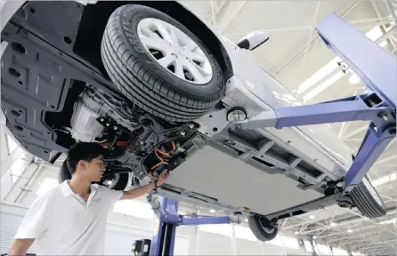  ?? FILE PHOTO: REUTERS ?? An employee examines the battery of an E150 EV electric car at a factory of the plans to open an R11 billion car assembly plant in Port Elizabeth by 2018. Beijing Automotive Industry Holding Company on the outskirts of Beijing. The company