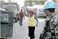  ??  ?? UN peacekeepe­rs and US soldiers secure a food distributi­on point in Haiti in the aftermath of the Jan. 12, 2010 earthquake. Credit: UN Photo/Sophia Paris